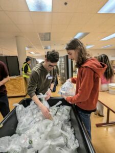 Teens work at a food pantry