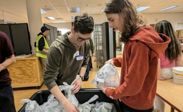 Teens work at a food pantry